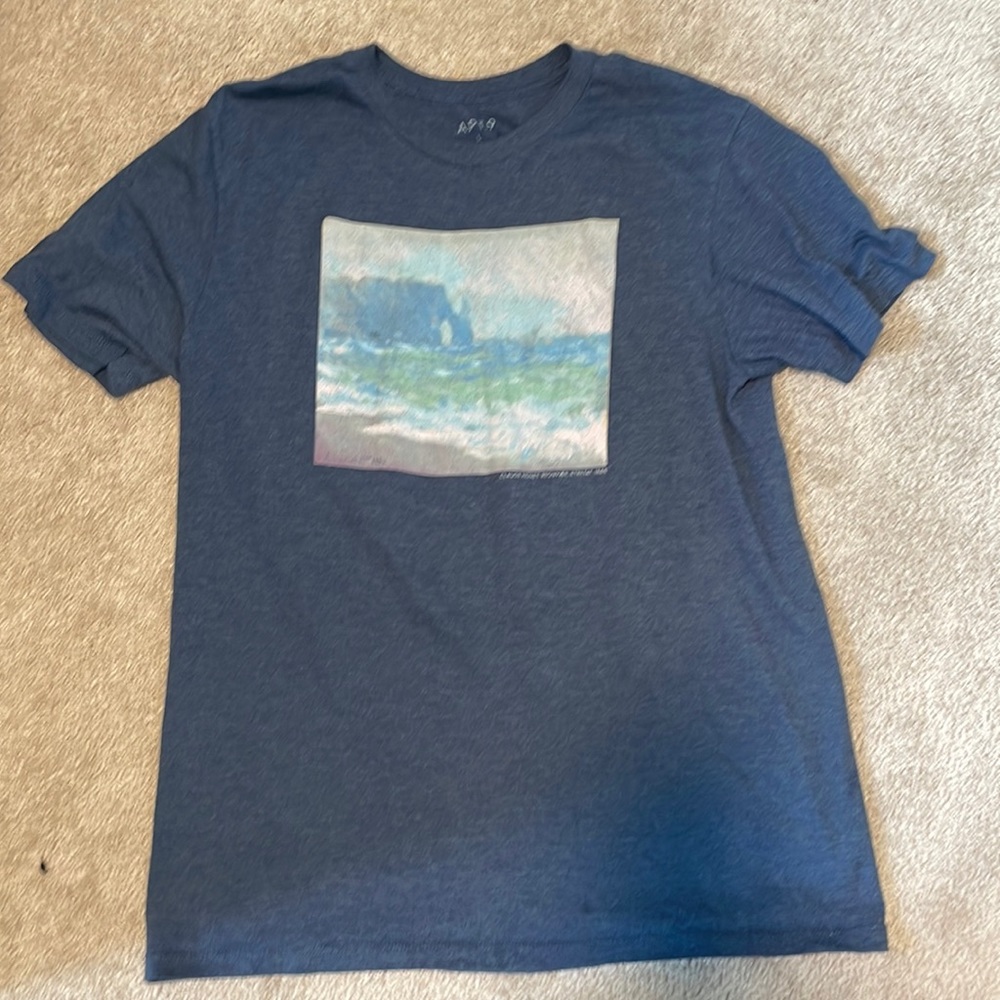 blue shirt with art on front